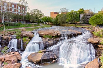 View at Greenville downtown waterfall in Falls park from the hanging bridge. Beautiful, powerful and very attractive for visitors.
