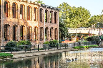 The Reedy River gently flows through the city district of Greenville, South Carolina. This river and walkway offers a peaceful setting to locals and visitors alike. As the sun sets on the city the reflection brought the with it a peaceful setting.
